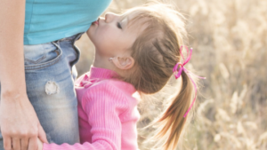 toddler kissing mother belly